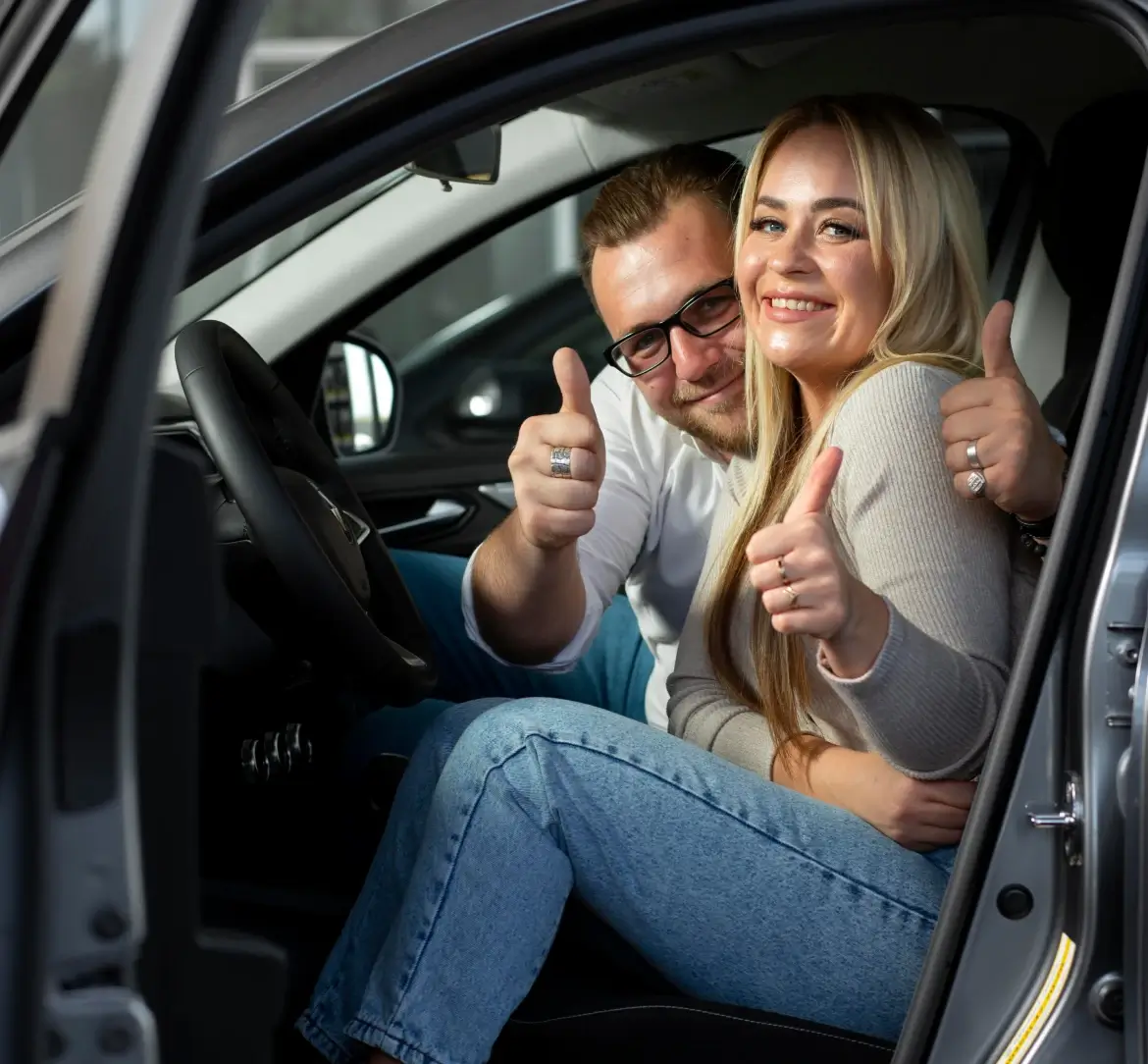 Happy travelers completing a car rental booking